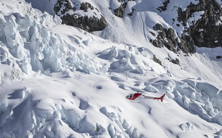 A helicopter on snow high in the Southern Alps near Aoraki
