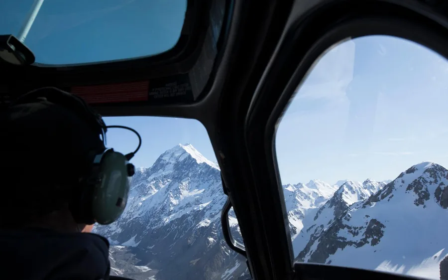 The view forward from a helicopter cockpit towards Aoraki